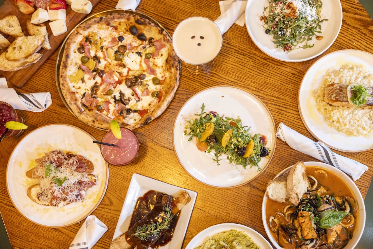 Overhead view of Farmer's Table brunch spread featuring the Barn Yard Bloody Mary and farm-fresh plates in La Mesa